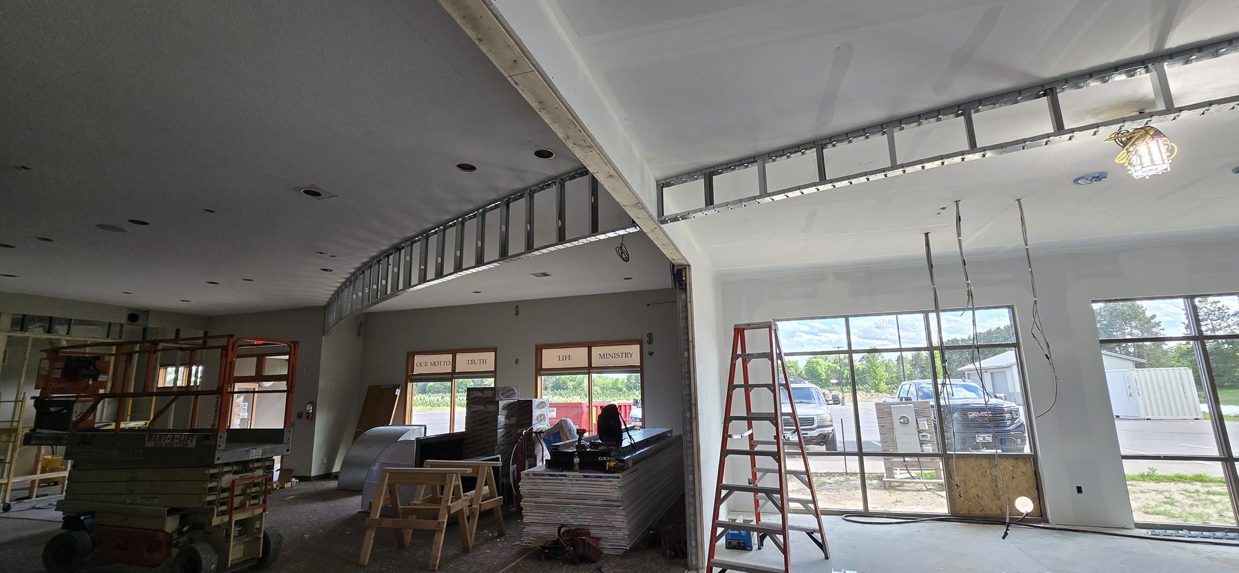 Commercial drywall buildout with ceiling grid and curved soffit work by Finishing Touch, LLC in St. Paul, MN